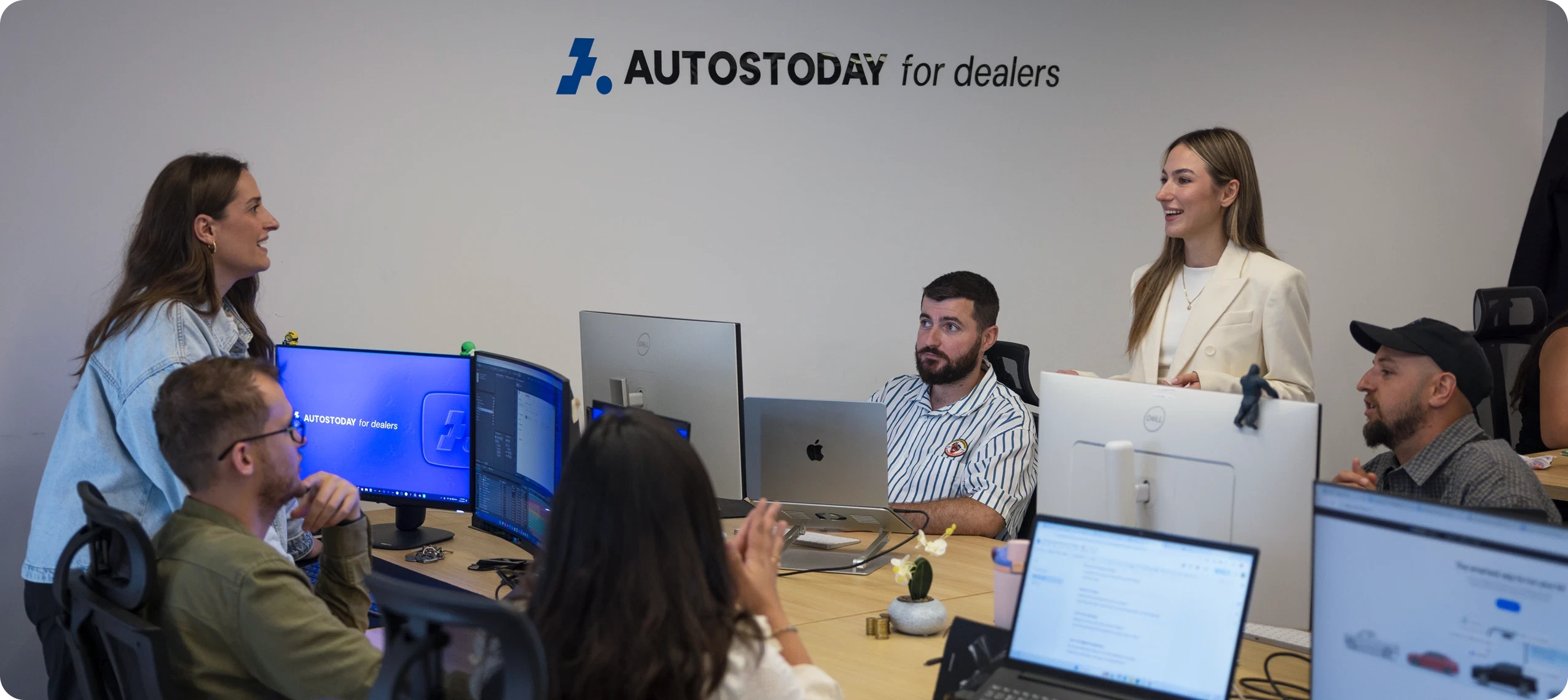The AutosToday for Dealers team collaborating in the office