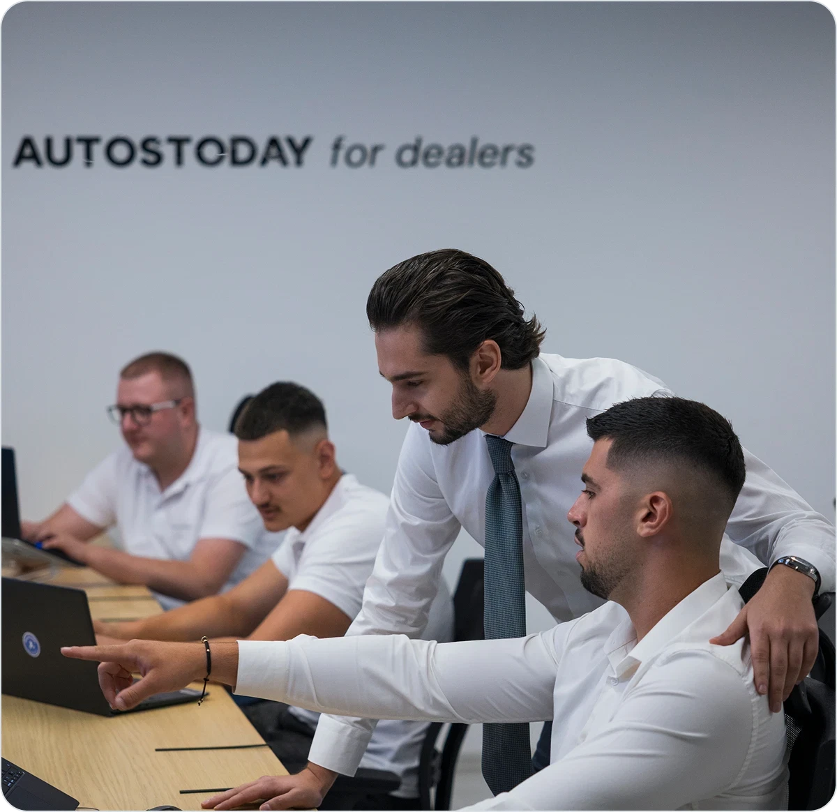 AutosToday for Dealers team members reviewing the platform together